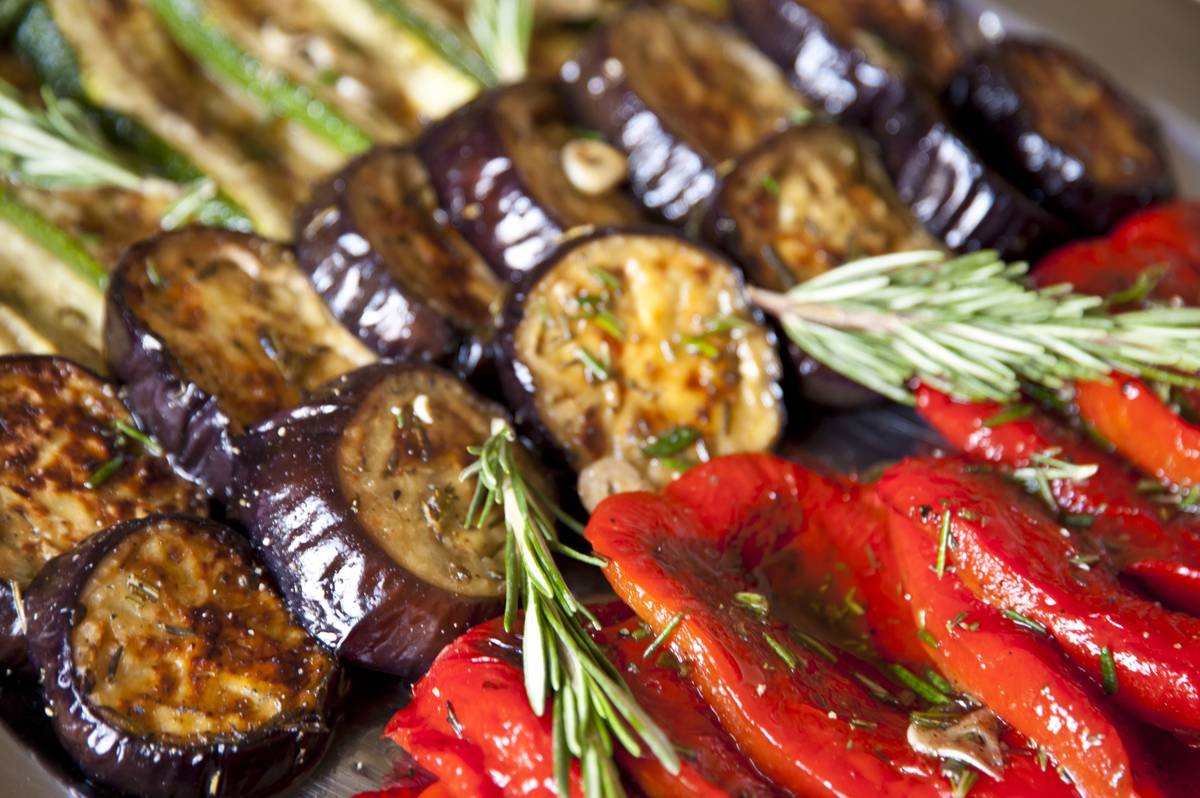 A platter of grilled aubergine, courgette and roasted red peppers with rosemary.